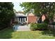 Charming backyard with patio, table, chairs, and lush landscaping at 1021 Isleworth Ave, Charlotte, NC 28203
