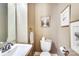 Bathroom has a pedestal sink, neutral color palette and contemporary fixtures, combining functionality with an elegant style at 1021 Isleworth Ave, Charlotte, NC 28203