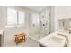 Bathroom with glass enclosed shower, mosaic floors, wood bench, and a double vanity at 1021 Isleworth Ave, Charlotte, NC 28203