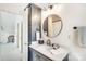 Charming bathroom featuring a round mirror, quartz counters, and modern fixtures at 1021 Isleworth Ave, Charlotte, NC 28203