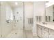 Bathroom with glass enclosed shower, mosaic floors, and a double vanity with modern faucets at 1021 Isleworth Ave, Charlotte, NC 28203