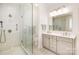 Bathroom featuring glass-enclosed shower, white subway tile, and gray double vanity at 1021 Isleworth Ave, Charlotte, NC 28203