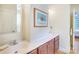 Bathroom with double vanity, marble countertop, framed art, and doorway access to bedroom at 1021 Isleworth Ave, Charlotte, NC 28203
