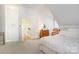 Angled bedroom with neutral carpet, a bed, access to other rooms, and natural light at 1021 Isleworth Ave, Charlotte, NC 28203