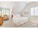 Bedroom with neutral carpet, and a bed placed near the window with an angled wall at 1021 Isleworth Ave, Charlotte, NC 28203
