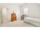 Bedroom with neutral carpet, a bed, and a desk with a chair near the window at 1021 Isleworth Ave, Charlotte, NC 28203