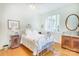 Bright bedroom with wood floors, plenty of natural light, and a stylish bed, creating a comfortable and peaceful atmosphere at 1021 Isleworth Ave, Charlotte, NC 28203