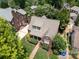 Aerial view of a beautiful brick home with lush landscaping and mature trees at 1021 Isleworth Ave, Charlotte, NC 28203