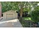 Detached garage with a paved driveway and fenced yard at 1021 Isleworth Ave, Charlotte, NC 28203