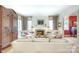 Elegant living room featuring a fireplace, neutral furniture, hardwood floors, and natural light at 1021 Isleworth Ave, Charlotte, NC 28203