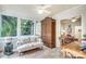 Sunroom with lots of natural light, tile floor and casual seating perfect for enjoying nature at 1021 Isleworth Ave, Charlotte, NC 28203