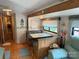 Camper dining area featuring a dinette and wood-look flooring at 103 Powder Horn Trl, Mount Gilead, NC 27306