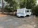 Prowler camper parked on a gravel lot, surrounded by trees at 103 Powder Horn Trl, Mount Gilead, NC 27306