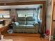 Camper living area with couch, blinds, and decor at 103 Powder Horn Trl, Mount Gilead, NC 27306