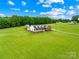 An aerial view of the house with a large lawn, and green woods at 106 Laren Rd, Shelby, NC 28152