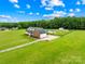 An aerial view of a brick home with an in ground pool and plenty of land at 106 Laren Rd, Shelby, NC 28152