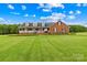 Charming brick home with a pristine front yard, inviting porch, and colorful flower beds at 106 Laren Rd, Shelby, NC 28152