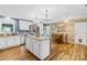 Open kitchen boasts white cabinets, granite counters, an island, and a wood plank accent wall at 106 Laren Rd, Shelby, NC 28152