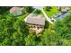 Aerial shot of backyard oasis, complete with a cozy patio and inviting fire pit nestled among mature trees at 110 St Sophia Ct, Mooresville, NC 28117