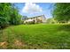 Expansive backyard with mature trees and landscaping, offering ample space for recreation and outdoor living at 110 St Sophia Ct, Mooresville, NC 28117