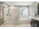 Bright bathroom showcasing a glass shower, soaking tub, and neutral color scheme at 110 St Sophia Ct, Mooresville, NC 28117