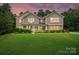 Inviting two-story home featuring a large, manicured front lawn and a charming, light blue front door at 110 St Sophia Ct, Mooresville, NC 28117