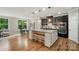 Bright kitchen featuring dark cabinets, granite countertops, stainless appliances, and center island with seating at 110 St Sophia Ct, Mooresville, NC 28117