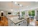 Bright kitchen with granite island and stainless steel appliances flows to a living room with fireplace and built ins at 110 St Sophia Ct, Mooresville, NC 28117