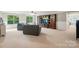 Spacious living room with large windows, plush seating, and built-in wooden entertainment center at 110 St Sophia Ct, Mooresville, NC 28117