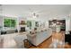 Bright open-concept living area with hardwood floors, fireplace, and a seamless transition into the modern kitchen at 110 St Sophia Ct, Mooresville, NC 28117