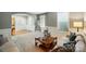 Bright living room featuring large windows, neutral decor, and a comfortable seating area with carpeted floors at 110 St Sophia Ct, Mooresville, NC 28117