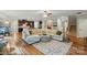 Open-concept living space with hardwood floors and seamless flow between living room, kitchen, and dining area at 110 St Sophia Ct, Mooresville, NC 28117