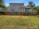 The backyard with a deck and a stone retaining wall ready for landscaping at 12092 Spinnaker Dr, Fort Mill, SC 29708