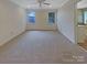 Spacious bedroom with neutral carpet and trim, natural light, and ceiling fan at 12092 Spinnaker Dr, Fort Mill, SC 29708