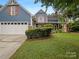 Charming blue two-story home with a white garage door and well-manicured lawn at 12092 Spinnaker Dr, Fort Mill, SC 29708