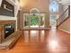 Open-concept living room with hardwood floors, fireplace, and natural light at 12092 Spinnaker Dr, Fort Mill, SC 29708