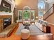 Bright living room featuring a fireplace, high ceilings, and views of the backyard at 12092 Spinnaker Dr, Fort Mill, SC 29708