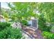 Lush backyard with a seating area, landscaping, a wooden pergola, a storage shed, and manicured lawn at 12311 Bentcreek Ln, Matthews, NC 28105