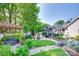 Beautiful backyard with a pergola, outdoor seating area, grilling area, lush landscaping, and manicured lawn at 12311 Bentcreek Ln, Matthews, NC 28105