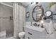 Elegant bathroom with a marble vanity, decorative mirror, and tiled walk-in shower at 12311 Bentcreek Ln, Matthews, NC 28105