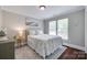 Comfortable bedroom showcasing hardwood floors, a side table, and neutral walls at 12311 Bentcreek Ln, Matthews, NC 28105