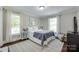 Bright bedroom featuring hardwood floors, neutral paint, large windows and stylish decor at 12311 Bentcreek Ln, Matthews, NC 28105