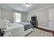 Cozy bedroom featuring neutral paint, hardwood floors and a modern entertainment center at 12311 Bentcreek Ln, Matthews, NC 28105