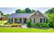 Charming one-story brick home with well-manicured lawn and inviting front porch at 12311 Bentcreek Ln, Matthews, NC 28105
