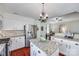 Bright kitchen featuring white cabinets, stainless steel appliances, granite countertops and hardwood floors at 12311 Bentcreek Ln, Matthews, NC 28105