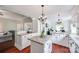 Bright eat-in kitchen featuring two islands, white cabinets, granite countertops and hardwood floors at 12311 Bentcreek Ln, Matthews, NC 28105