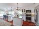 Bright kitchen featuring white cabinets, stainless steel appliances, granite countertops and hardwood floors at 12311 Bentcreek Ln, Matthews, NC 28105