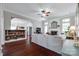 Cozy living room featuring a fireplace, dark wood floors, and open access to kitchen at 12311 Bentcreek Ln, Matthews, NC 28105