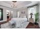Primary bedroom boasts hardwood floors, a tray ceiling, and comfortable furniture at 12311 Bentcreek Ln, Matthews, NC 28105