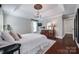 Primary bedroom boasts hardwood floors, a tray ceiling, and comfortable furniture at 12311 Bentcreek Ln, Matthews, NC 28105